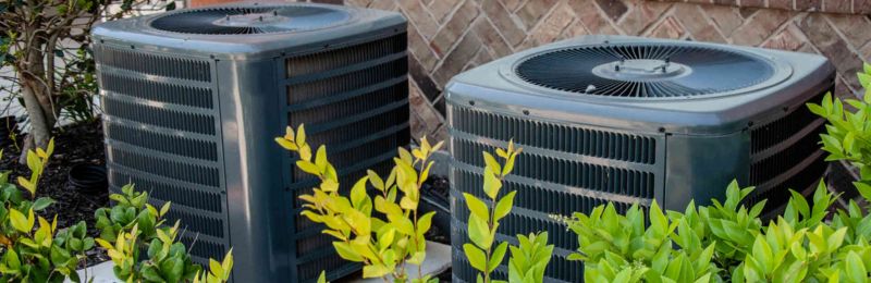 HVAC technician repairing an air conditioner unit in San Diego CA